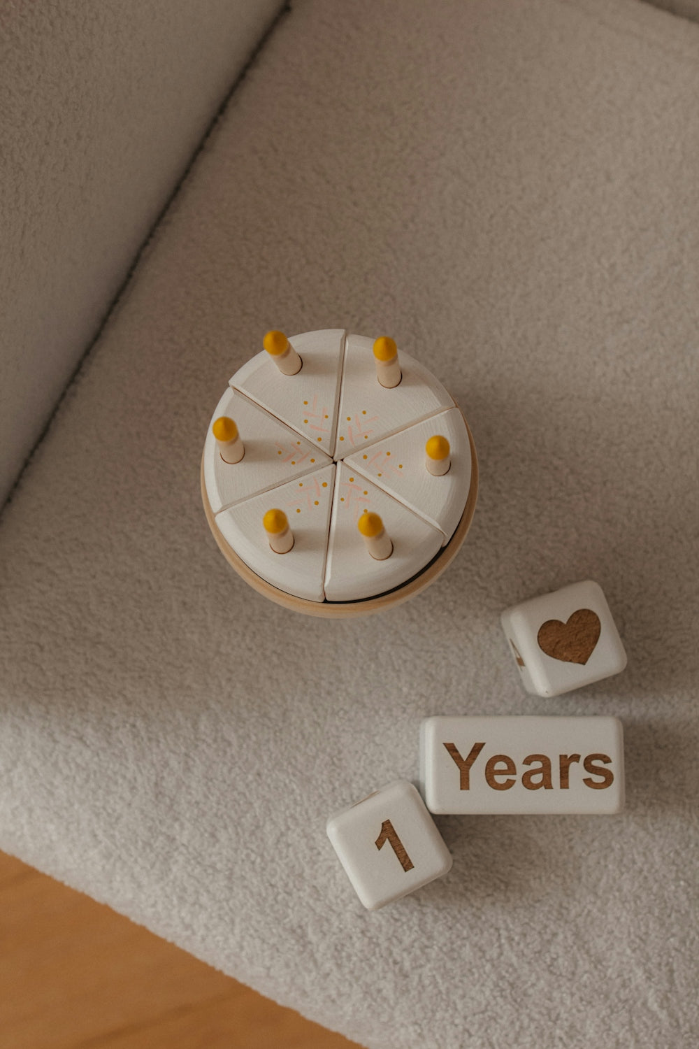 Wooden cake with candles and number 1 for celebration.