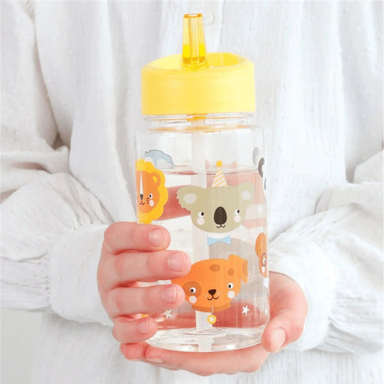 Boy holding children's water bottle with yellow cap and cute animal drawings
