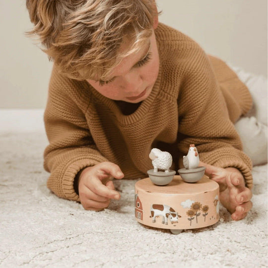 Caja musical de madera con temática de granja, incluye figuras de animales que giran al ritmo de la música, ideal para niños
