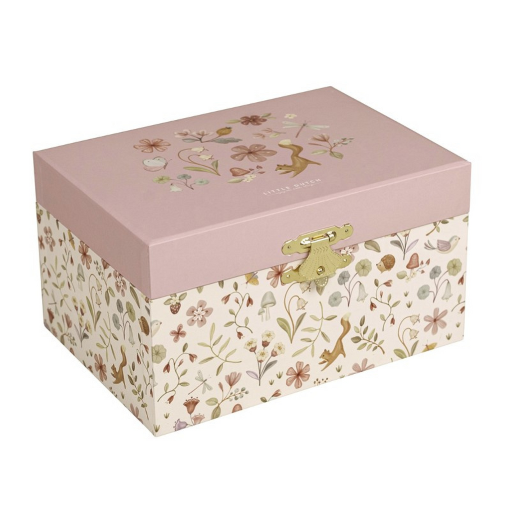 Caja de música infantil cerrada con ilustraciones de flores y animales en tonos pastel, con tapa rosa