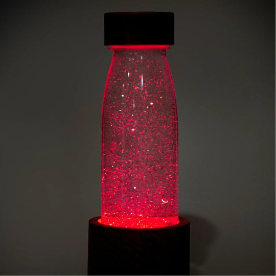 Sensory bottle [[PH_79f6830e-cf2d-4036-b233-cda0c2bfe8a]] with red light on for children's sensory play