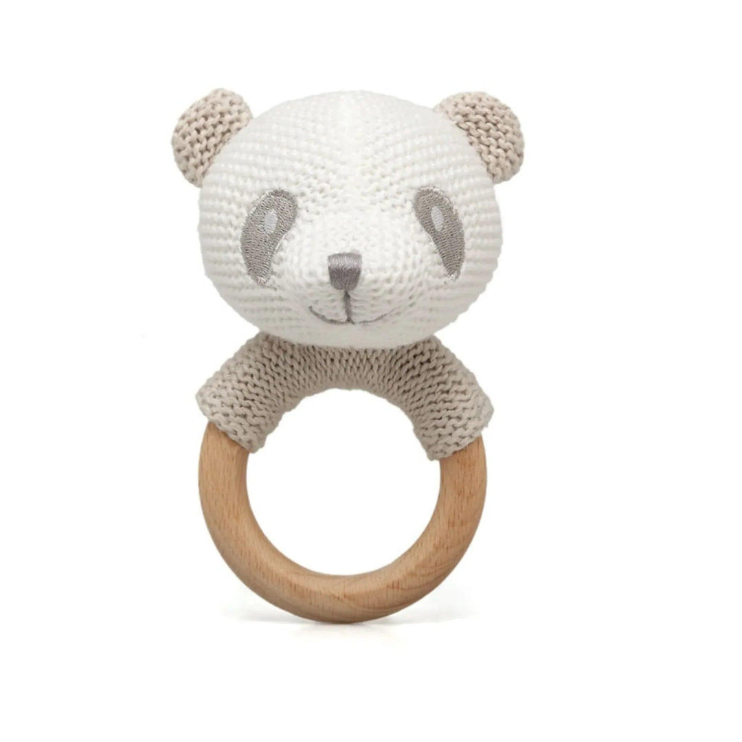 Bébé tenant un anneau de dentition panda crocheté avec un anneau en bois