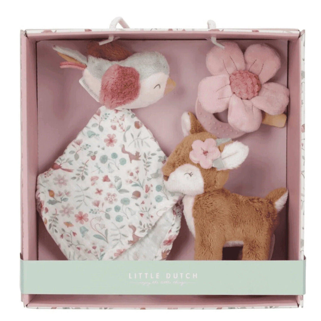 Pink box with padded interior containing a stuffed animal, teether and printed blanket