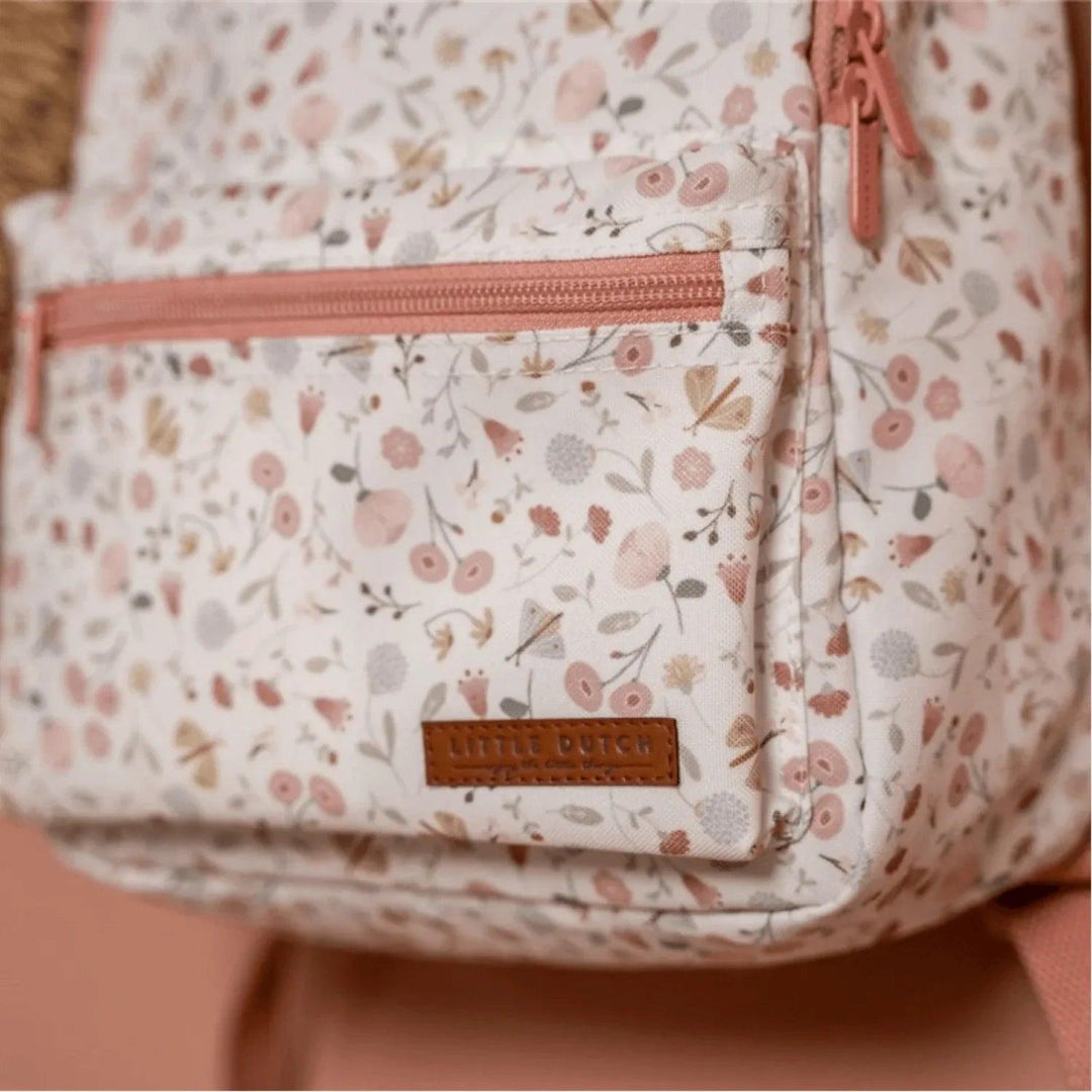 Gros plan de la poche avant avec le logo Little Dutch sur un sac à dos fleuri