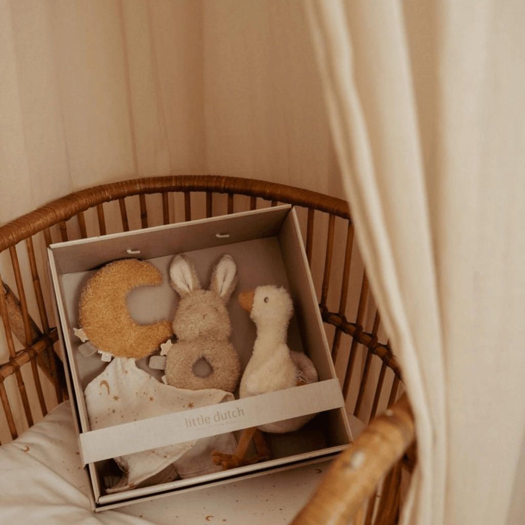 Set de regalo para bebé Little Dutch con peluches y muselina presentado en caja sobre cuna de mimbre
