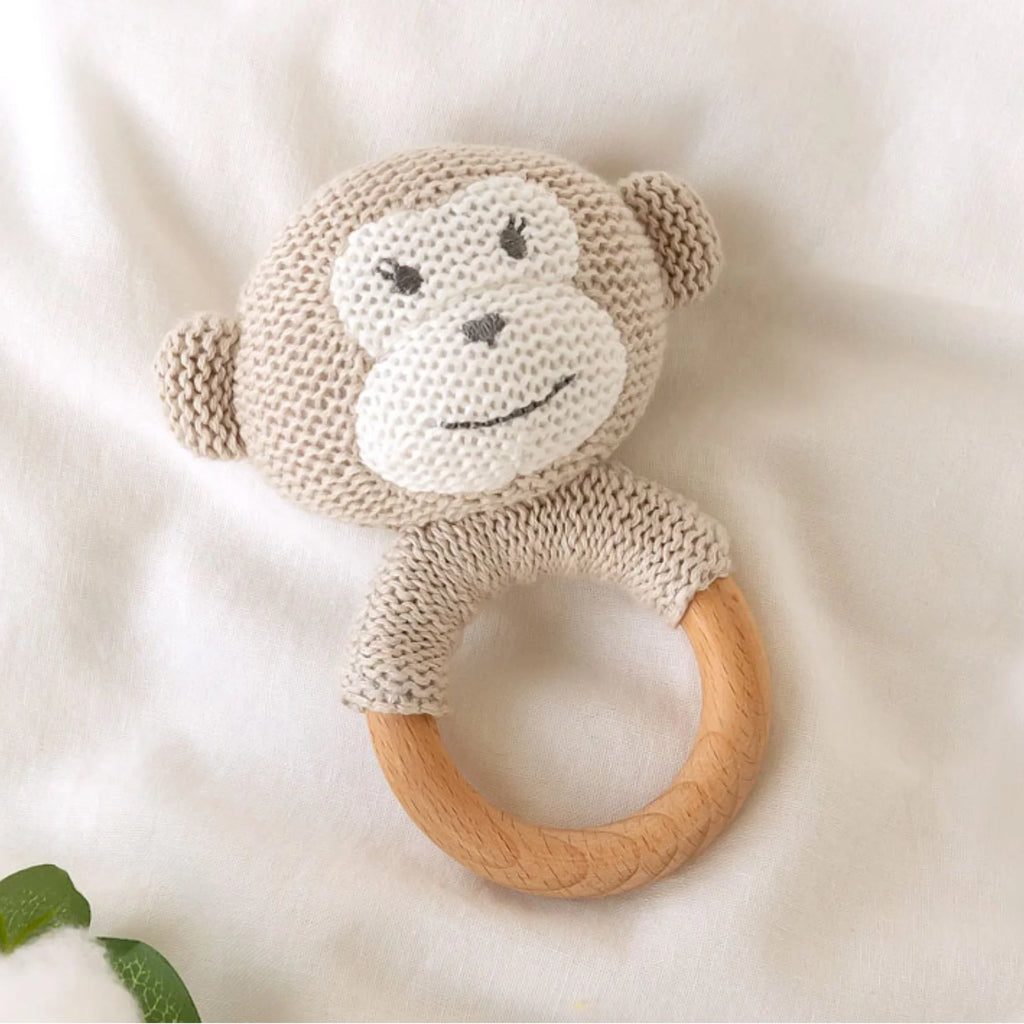 Baby teething rattle with woven monkey head and eco-friendly wooden ring.