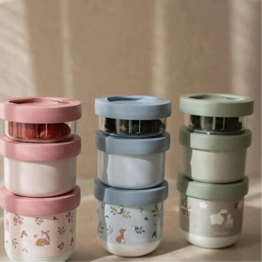 Tres sets de contenedores apilables Little Dutch en rosa, azul y verde con motivos naturales