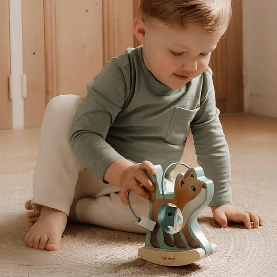 Boy playing with the wooden rocking fox Little Dutch, Interactive educational toy