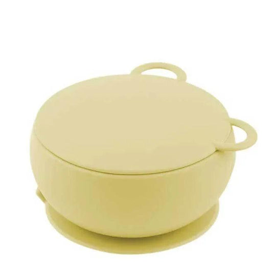 Silicone bowl with suction cup base and pastel yellow color.